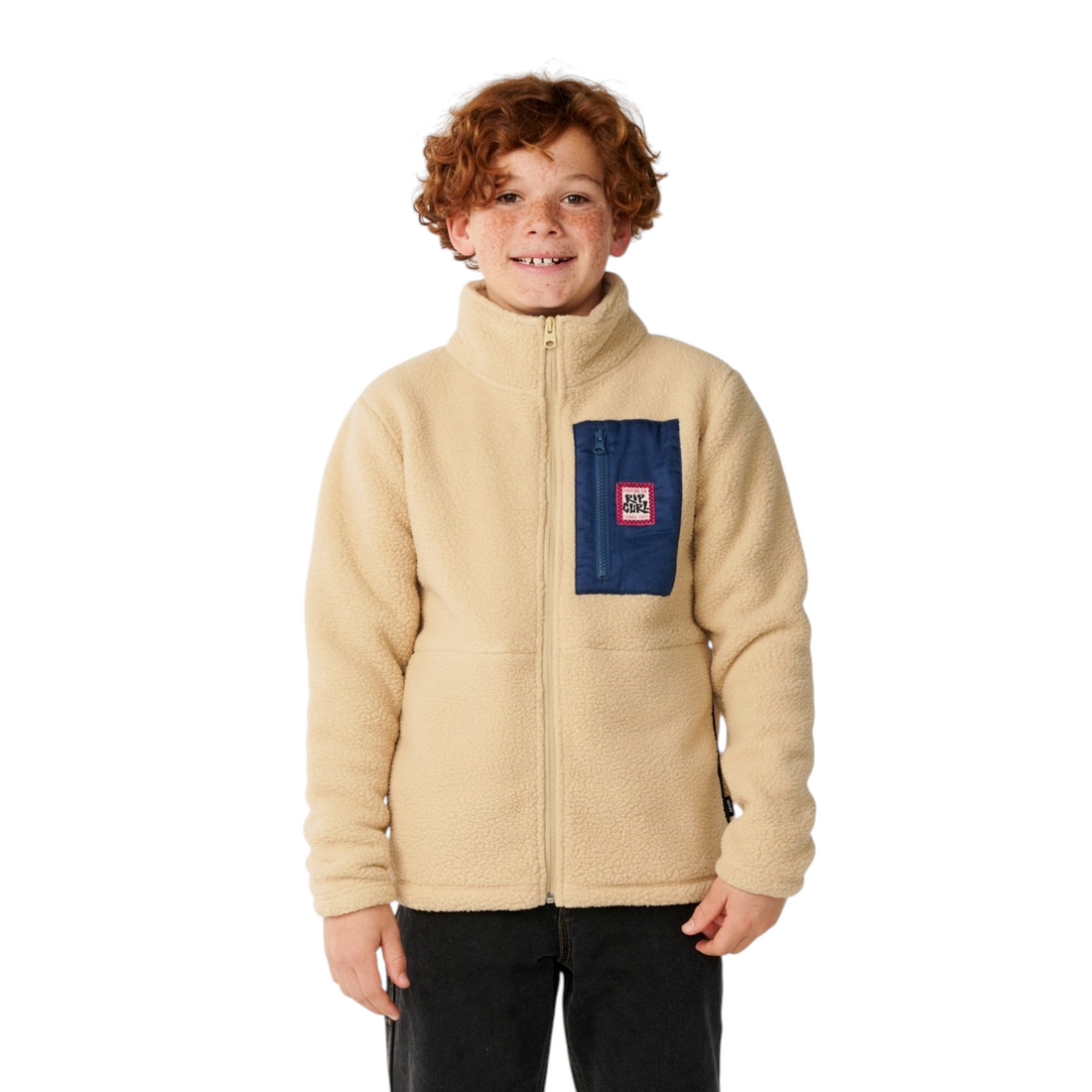 Garçon portant une veste polaire Born2ride Rip Curl Streamline beige avec poche poitrine bleue zippée