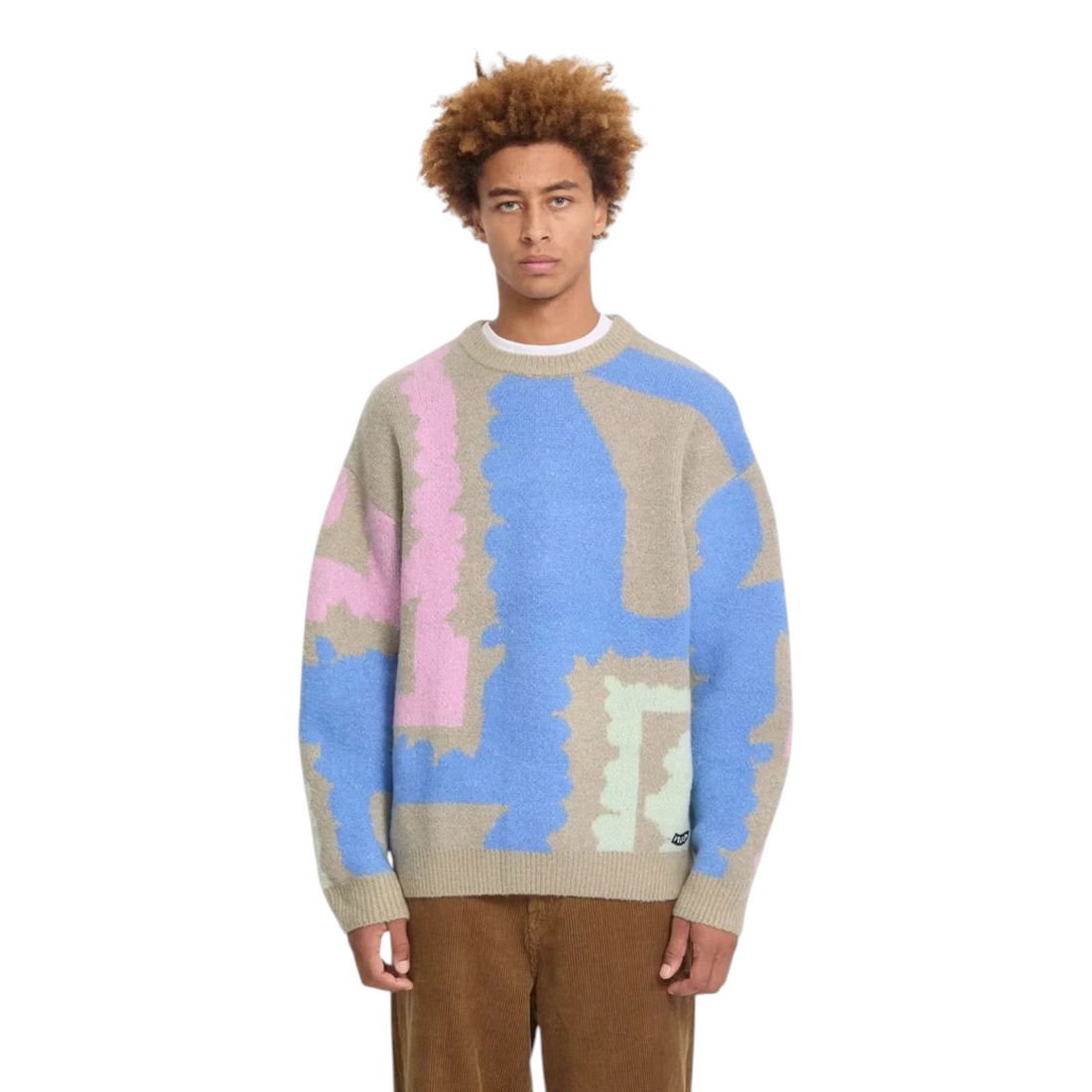 Homme portant le pull Born2ride Volcom Fa Carrau à motifs géométriques colorés bleu, rose et beige